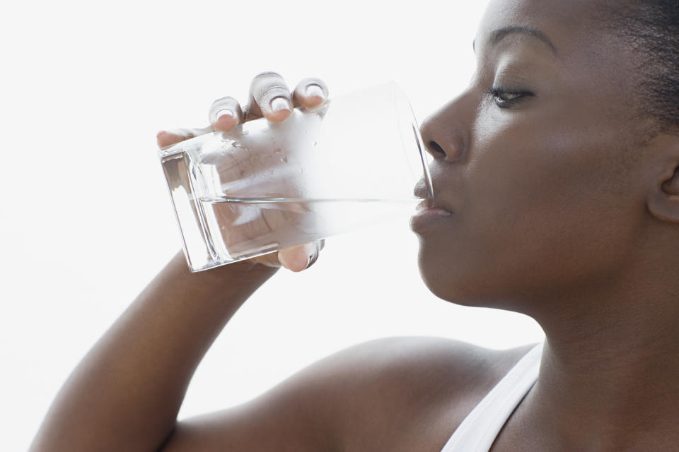 Person drinking water from a glass