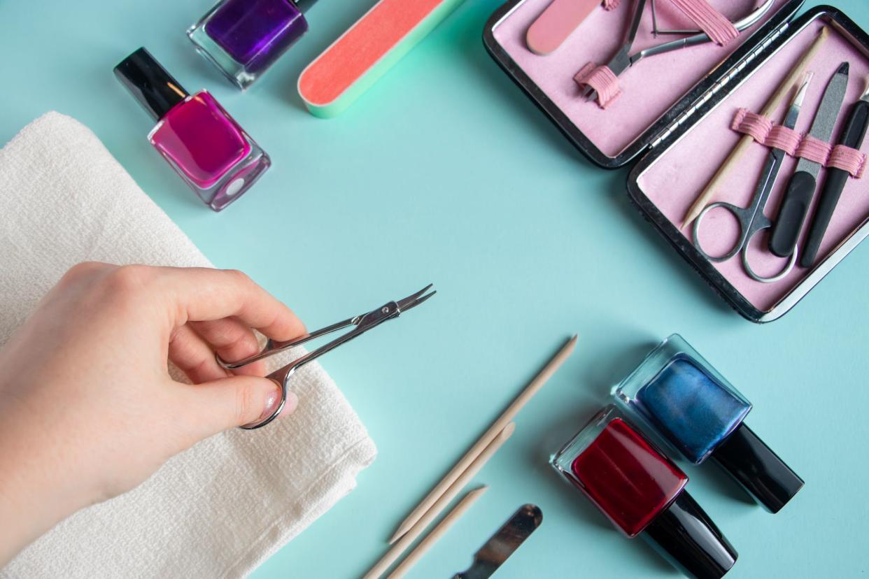 Workplace in a nail salon. A set of tools for hand care on a blue background. Place for text.