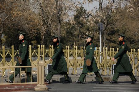 Paramilitary police officers patrol ahead of the plenary session of National People's Congress in Beijing, China March 2, 2018. REUTERS/Thomas Peter