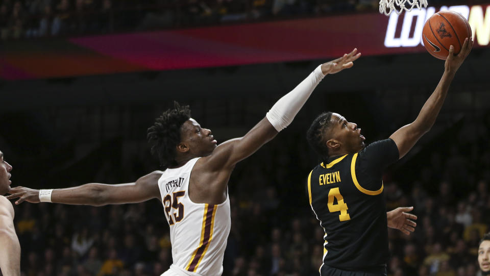 Iowa's Bakari Evelyn goes up to the basket past Minnesota's Daniel Oturu during the second half of an NCAA college basketball game Sunday, Feb. 16, 2020, in Minneapolis. Iowa won 58-55. (AP Photo/Stacy Bengs)