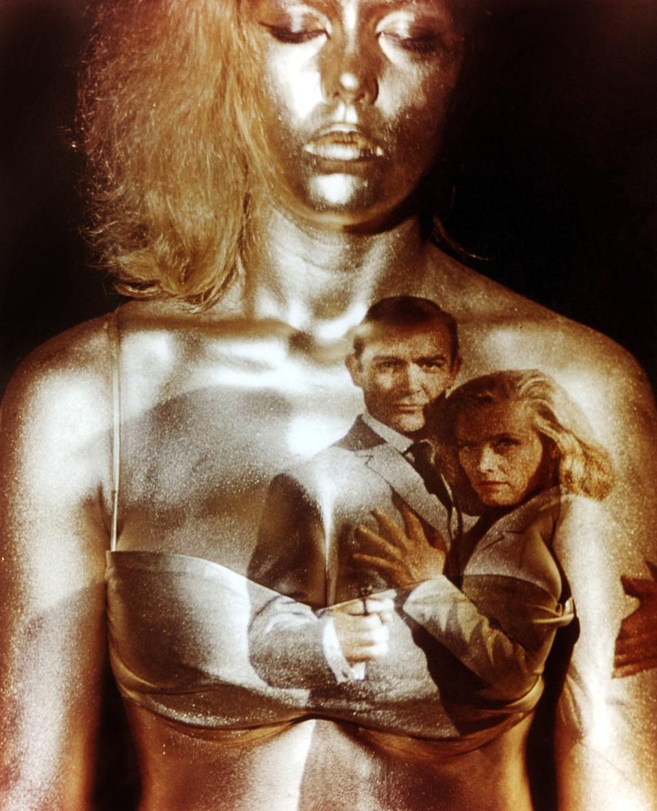 Margaret Nolan as the gold-painted backdrop for the opening title sequence of Goldfinger - Moviestore/Shutterstock