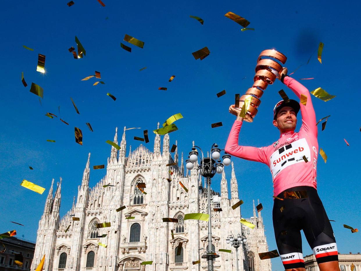 Tom Douholds lifts the trophy in the shadow of Milan's famous cathedral: Getty
