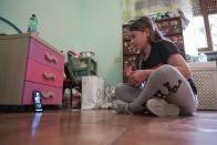 Elena Moretti looks at her cellphone as she prepares to attend an online dancing lesson, in her bedroom in Rome, Thursday, May 14, 2020. For the 11-year-old, the COVID-19 coronavirus pandemic is not some faraway threat: Italy was the first European country to be hit by COVID-19, and her mother is a doctor in the public health system that has seen 25,000 personnel infected and more than 160 doctors dead nationwide. “The doctors are saving a bunch of people,” Elena said. “They’ve been very brave in confronting this.” (AP Photo/Andrew Medichini)