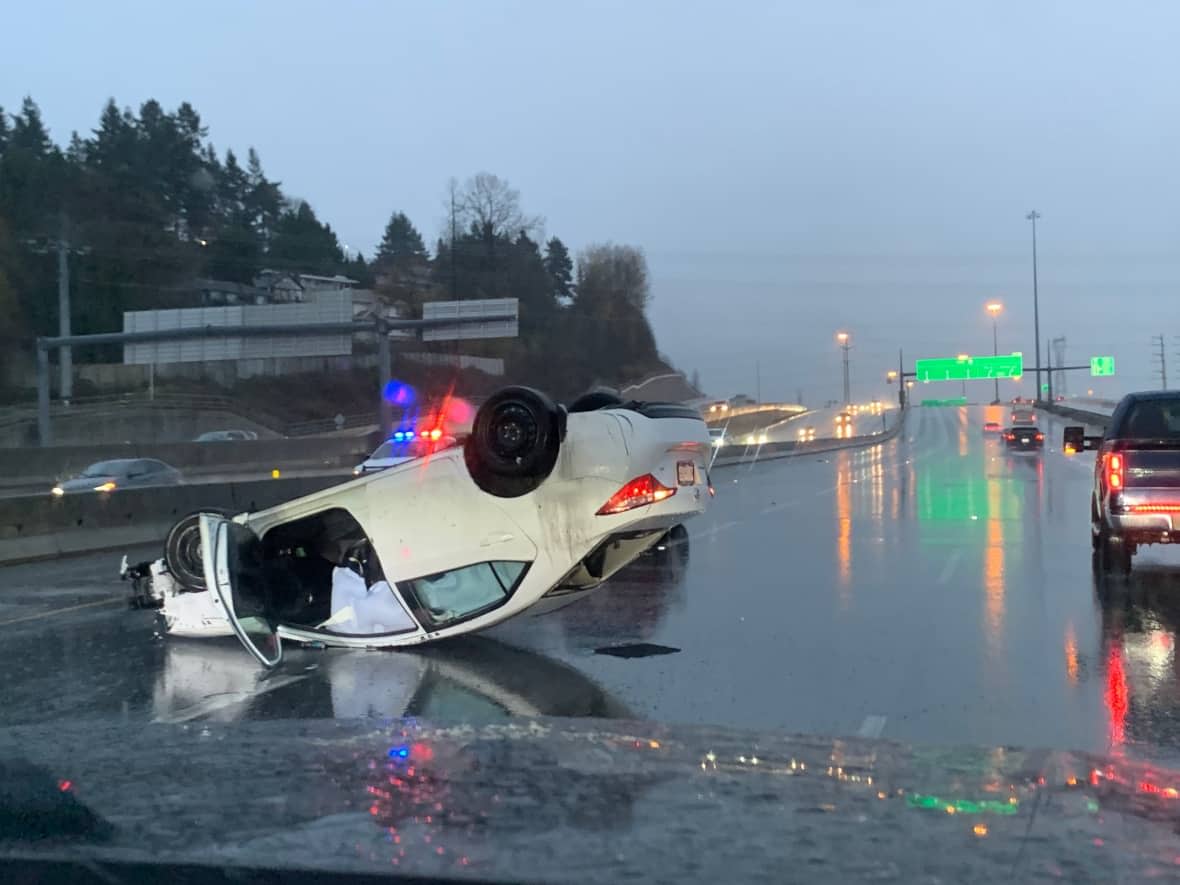 A car is overturned on the Trans-Canada Highway Sunday after heavy rain in southwest B.C. (Katie Nicholson/CBC - image credit)