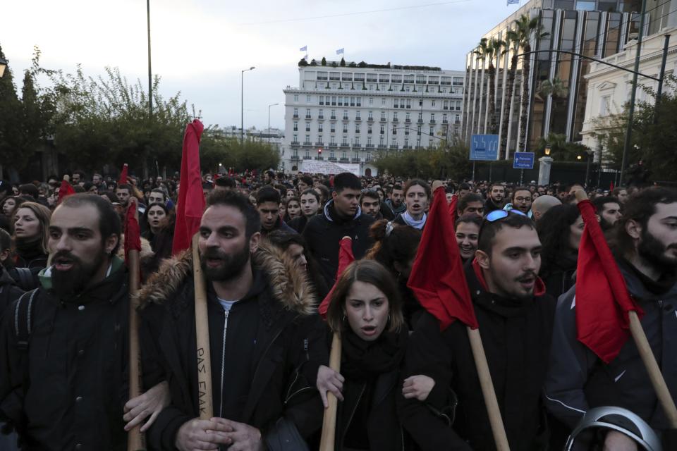 Protesters shout slogans during a rally in Athens, Saturday, Nov. 17, 2018. Several thousands people march to the U.S. Embassy in Athens under tight police security to commemorate a 1973 student uprising that was crushed by Greece's military junta, that ruled the country from 1967-74. (AP Photo/Yorgos Karahalis)