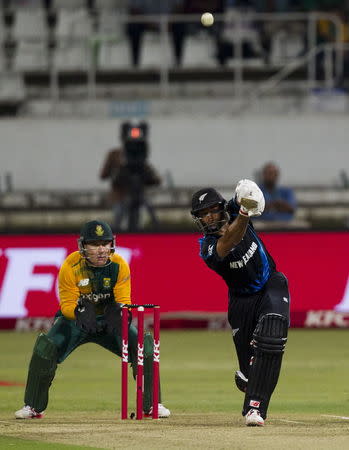 New Zealand's Grant Elliott plays a shot with South Africa's Morne van Wyk looking on during their T20 International cricket match in Durban, August 14, 2015. REUTERS/Rogan Ward