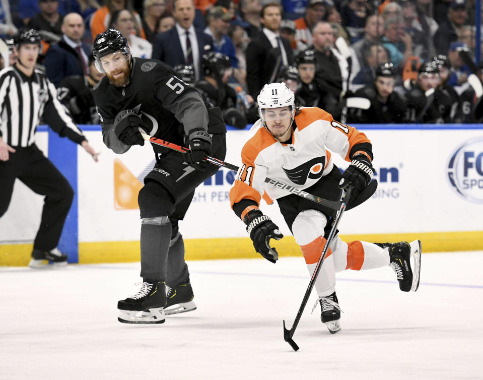 Tampa Bay Lightning defenseman Braydon Coburn (55) and Philadelphia Flyers right wing Travis Konecny (11) battle for the puck during an NHL hockey game Saturday, February 15, 2020, in Tampa, Fla. (AP Photo/Jason Behnken)