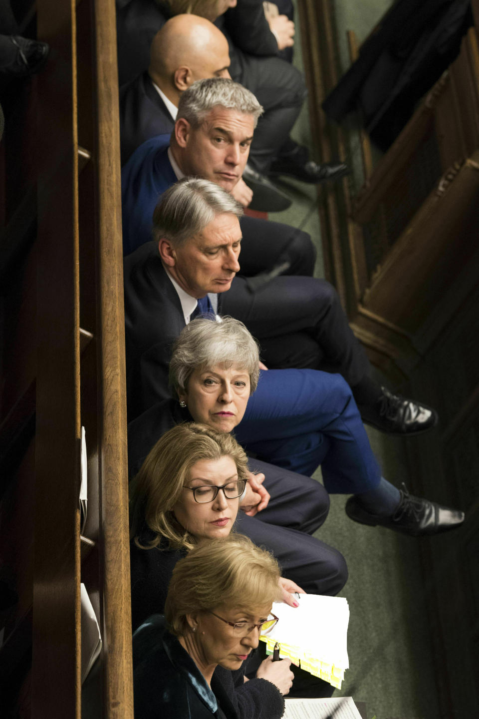In this handout photo made available by UK Parliament, Britain's Prime Minister Theresa May and her cabinet members listen, during Prime Minister's Questions in the House of Commons, London, Wednesday March 20, 2019. Exactly 1,000 days after Britain voted to leave the European Union, and nine days before it is scheduled to walk out the door, Prime Minister Theresa May hit the pause button Wednesday, asking the bloc to postpone the U.K.'s departure until June 30. (UK Parliament/Mark Duffy/via AP)