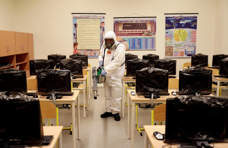 A worker in a protective suit disinfects a classroom inside of an elementary school due to coronavirus concerns in Prague, Czech Republic, March 10, 2020.   REUTERS/David W Cerny (Photo: David W Cerny / Reuters)