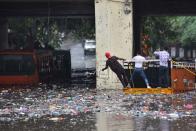 Rescue work underway to retrieve people trapped in buses that got stuck in water that collected under the Zakhira bridge after heavy rainfall, on July 19, 2020 in New Delhi, India. Moderate-to-heavy rain lashed several states in northern, eastern and coastal India on Sunday, but the monsoon activity continued to remain subdued in Delhi, which has recorded a 40 per cent rainfall deficiency despite an early onset of the seasonal weather system. (Photo By Sanchit Khanna/Hindustan Times via Getty Images)