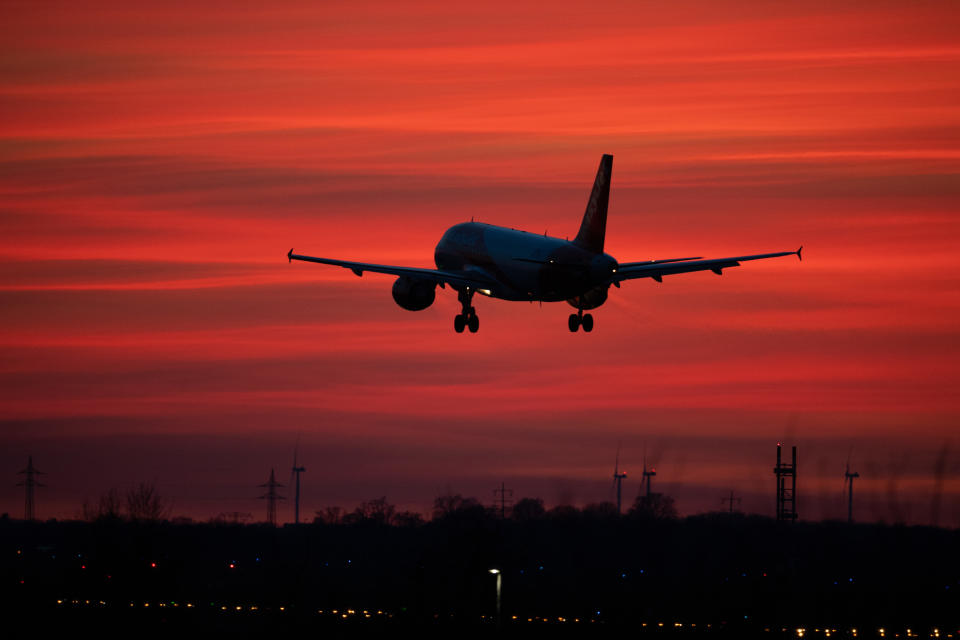 15 March 2020, Brandenburg, Schönefeld: An EasyJet aircraft lands at Schoenefeld Airport in a red evening sky. (to "Lütke Daldrup on the effects of Corona on Berlin Airports") Photo: Soeren Stache/dpa-Zentralbild/dpa (Photo by Soeren Stache/picture alliance via Getty Images)