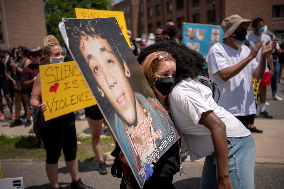 Cecilia Luna-Diaz holds an image of her son Elvin Diaz as she hugs Subiya Mboya, 19, on Ward Street in Hackensack as part of a Black Lives Matter rally on Saturday, June 6, 2020. Elvin Diaz was shot and killed by Hackensack police officers at his home in Hackensack on May 21, 2015.