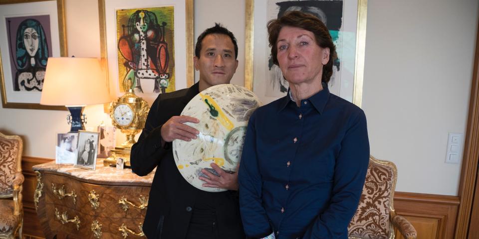 Marina Picasso, right, granddaughter of artist Pablo Picasso, and her son Florian Picasso pose with a ceramic art-work of Pablo Picasso