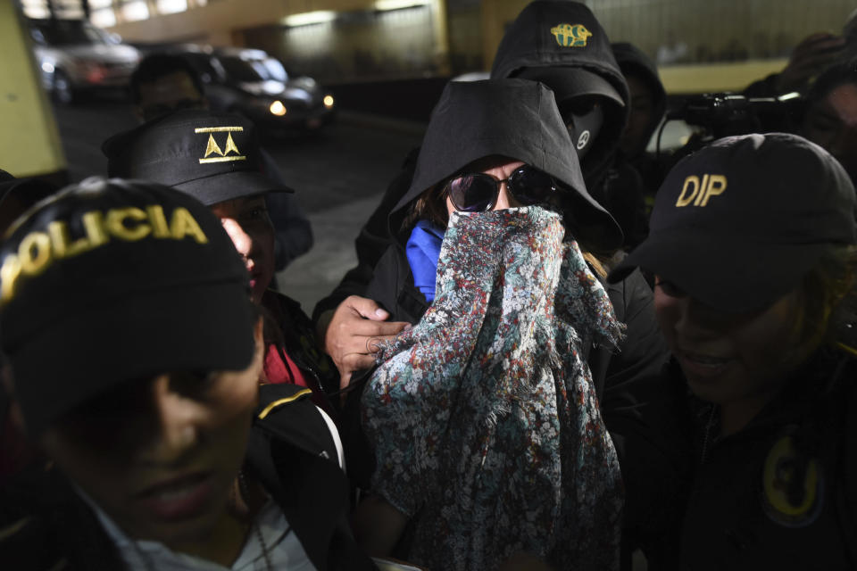 Former first lady and former presidential candidate Sandra Torres is escorted by police to court in Guatemala City, Monday, Sept. 2, 2019. Authorities arrested Torres at her home Monday on charges of campaign finance violations. (AP Photo/Oliver De Ros)