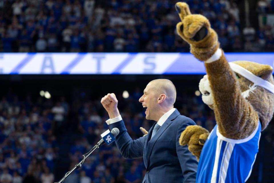 Mark Pope and the Kentucky Wildcat mascot fire up the Rupp Arena crowd during the new coach’s introductory press conference April 14.