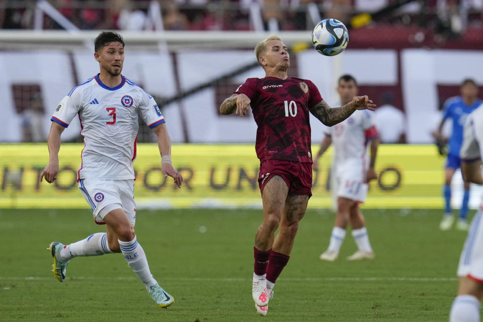 Venezuela's Yeferson Soteldo controls the ball as Chile's Guillermo Maripan looks on during a qualifying soccer match for the FIFA World Cup 2026 at Monumental stadium in Maturin, Venezuela, Tuesday, Oct. 17, 2023. (AP Photo/Ariana Cubillos)