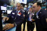 Specialist Mark Otto, left, works with traders at his post on the floor of the New York Stock Exchange, Friday, Aug. 16, 2019. Stocks are opening broadly higher at the end of a turbulent week. (AP Photo/Richard Drew)