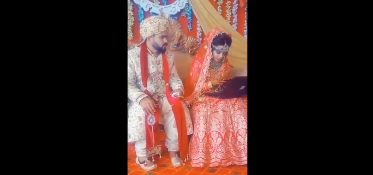 Screencap of bride occupied with her gadgets at her wedding.  —Twitter/@dineshjoshi70 pic
