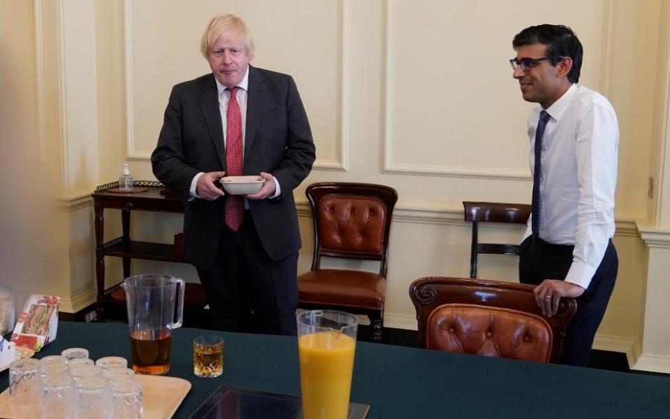 Prime Minister Boris Johnson (left) and Chancellor of the Exchequer Rishi Sunak at a gathering in the Cabinet Room in 10 Downing Street on his birthday