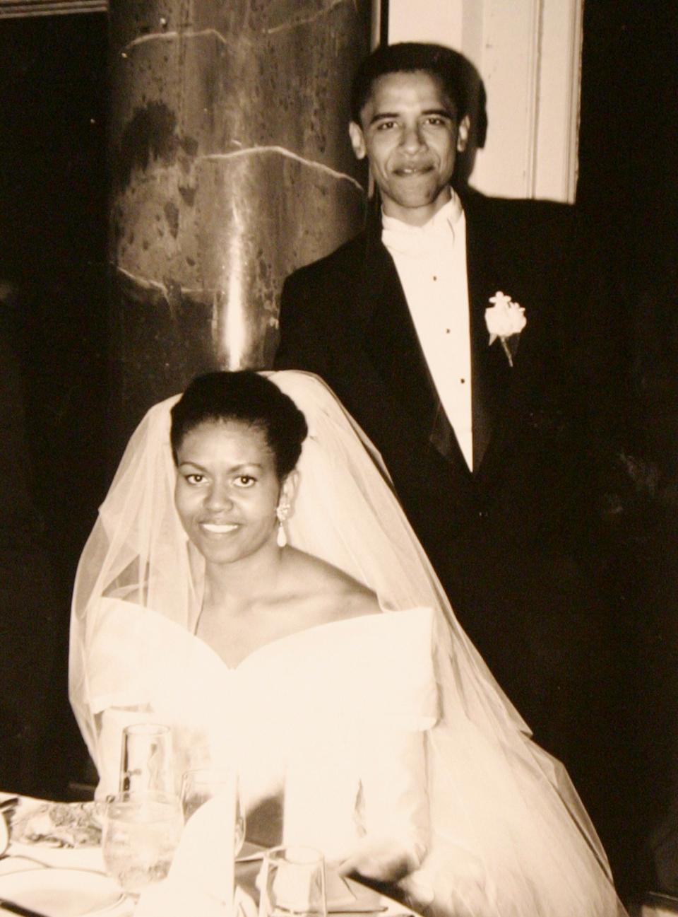 Michelle Obama wears a wedding dress, pictured with Barack on their wedding day