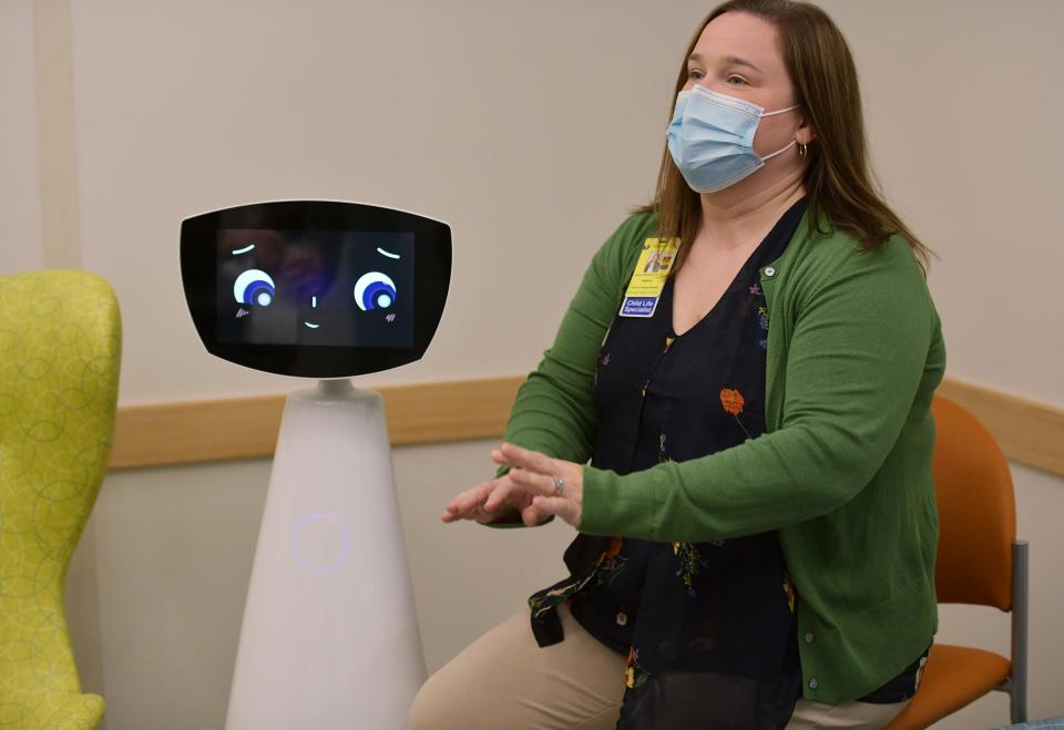 Kendra Frederick, manager of Child Life at Umass Memorial Health, University Campus interacts with “Robin” Tuesday, the new pediatric robot that interacts with kids. It is the third hospital in the country to have the human-assisted robot.