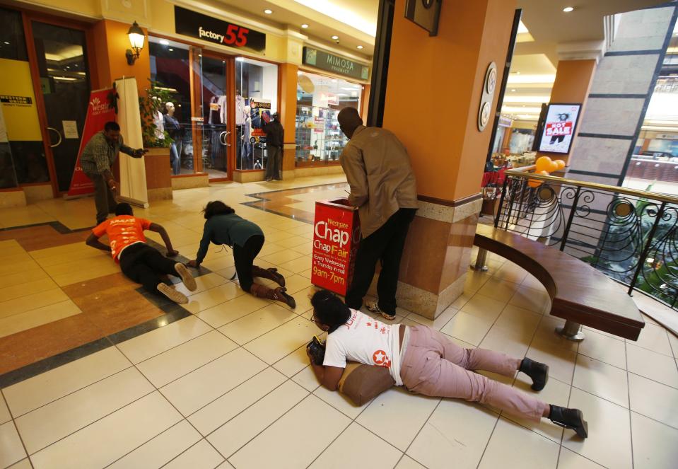 People scramble for safety as armed police hunt gunmen who went on a shooting spree at Westgate shopping center in Nairobi, September 21, 2013. (REUTERS/Goran Tomasevic)