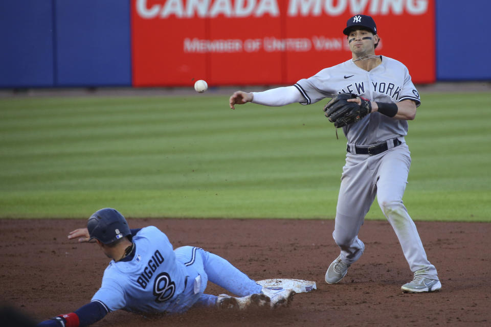 New York Yankees second baseman Tyler Wade throws to first after forcing out Toronto Blue Jays Cavan Biggio' out on a ball hit by Lourdes Gurriel Jr., who was out on the double play during the second inning of a baseball game Thursday, June 17, 2021, in Buffalo, N.Y. (AP Photo/Jeffrey T. Barnes)