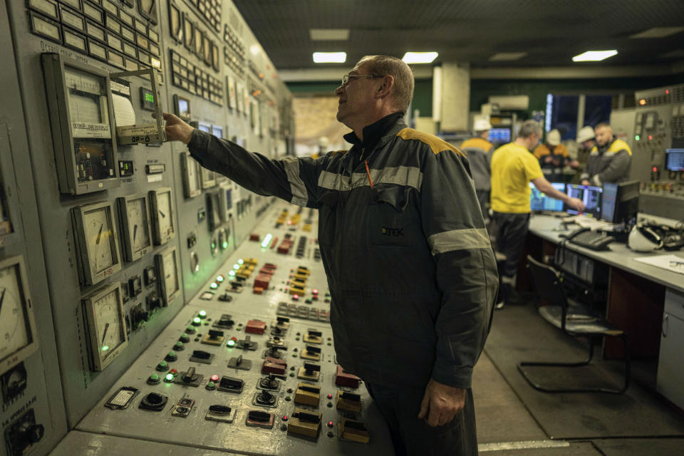 A worker reads the parameters in a power plant's control room in central Ukraine, Thursday, Jan. 5, 2023. When Ukraine was at peace, its energy workers were largely unheralded. War made them heroes. They're proving to be Ukraine's line of defense against repeated Russian missile and drone strikes targeting the energy grid and inflicting the misery of blackouts in winter. (AP Photo/Evgeniy Maloletka)