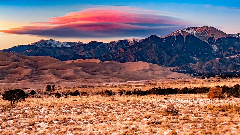Lenticular clouds appear to form mountains in the sky over Great Sand Dunes National Park in Nov. 2022.