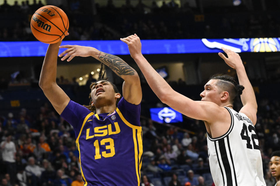 LSU forward Jalen Reed (13) goes against Vanderbilt forward Quentin Millora-Brown for the ball during the first half of an NCAA college basketball game in the second round of the Southeastern Conference tournament, Thursday, March 9, 2023, in Nashville, Tenn. (AP Photo/John Amis)