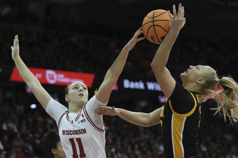 Wisconsin's Ana Guillen blocks Iowa's Sydney Affolter's shot during the first half of a women's NCAA college basketball game Sunday, Dec. 10, 2023, in Madison, Wis. (AP Photo/Morry Gash)