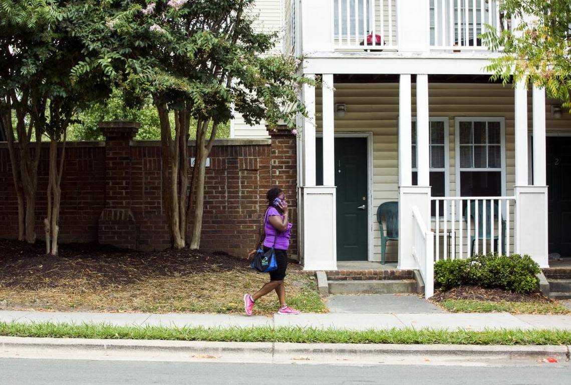 A pedestrian passes a public housing community on East Main St. on Tuesday, Sept. 5, 2017, in Durham, N.C.