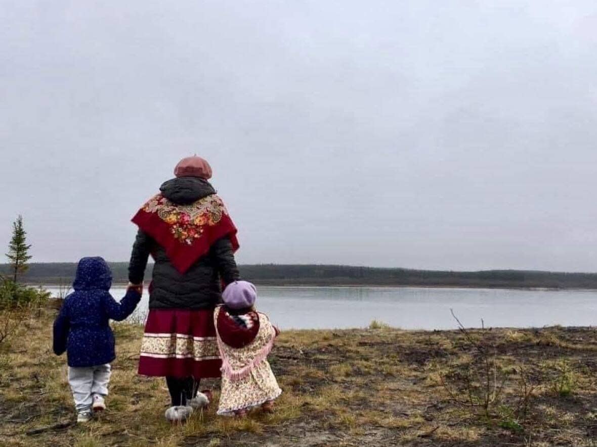 Saachipikinuukwau Bobbish walking in Chisasibi with her two daughters. She became a social worker after going through the foster care system herself as a teen.  (Submitted by Saachipikinuukwau Bobbish - image credit)