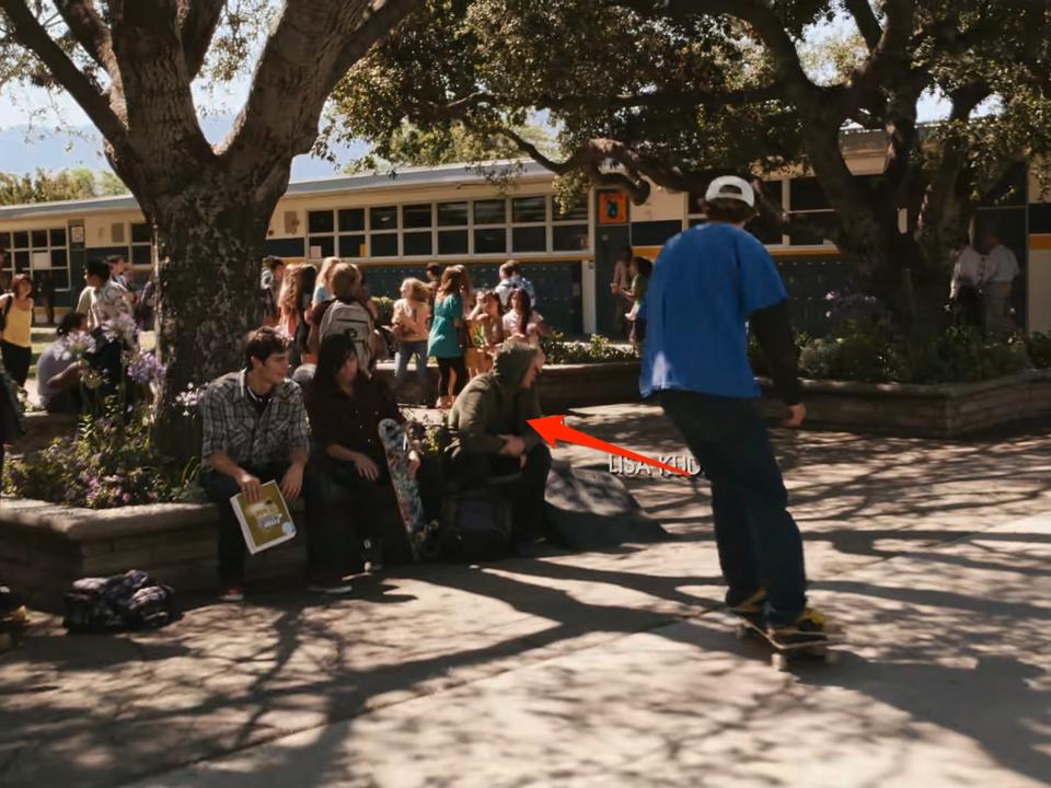 A red arrow pointing to a man wearing a hoodie in "Easy A."