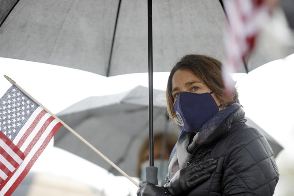 Massachusetts Attorney General Maura Healey is among the crowd that gathered along Park Street to pay her respects as the funeral procession for Capitol Police Officer William "Billy" Evans leaves St. Stanislaus Kotska Church after his funeral, Thursday, April 15, 2021, in Adams, Mass. Evans was killed this month when a driver struck him and another officer at a barricade outside the Senate. (Stephanie Zollshan/The Berkshire Eagle via AP)