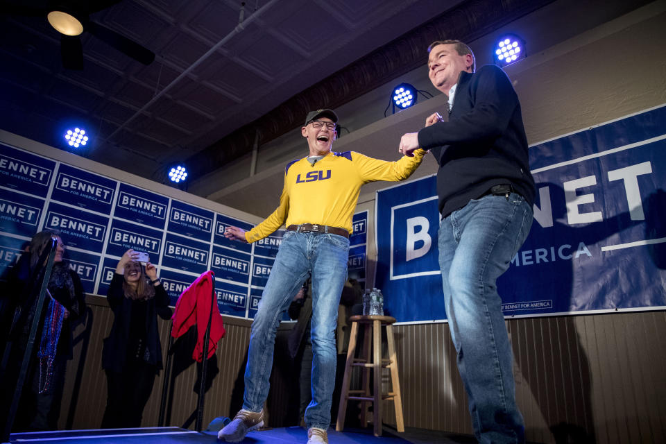 Sen. Michael Bennet, D-Colo., right, embraces James Carville, a political commentator known for leading former President Bill Clinton's 1992 presidential campaign, left, as he speaks at a campaign stop at the Spotlight Room at the Palace, Saturday, Feb. 8, 2020, in Manchester, N.H. (Andrew Harnik/AP)