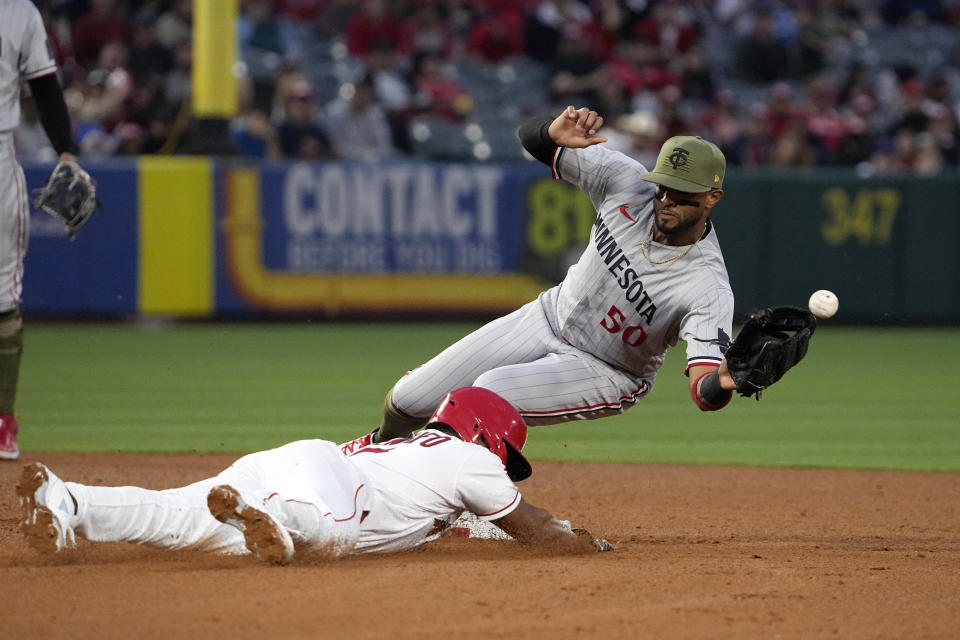 Los Angeles Angels' Luis Rengifo, left, steals second as Minnesota Twins second baseman Willi Castro misses the throw from home during the fourth inning of a baseball game Friday, May 19, 2023, in Anaheim, Calif. Angels' Brandon Drury scored on the play and Twins catcher Ryan Jeffers was charged with an throwing error on the play. (AP Photo/Mark J. Terrill)