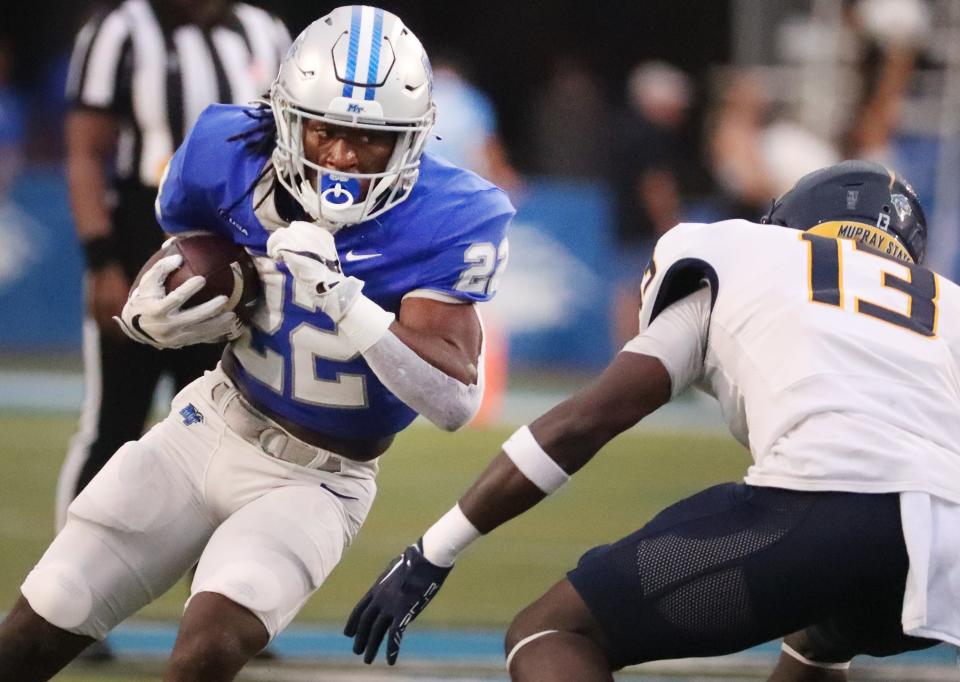 MTSU running back Jaiden Credle (22) runs the ball as Murray State defensive back KaVan Reed (13) moves in for the tackle during a football game at MTSU's Floyd Stadium on Saturday, Sept. 16, 2023.