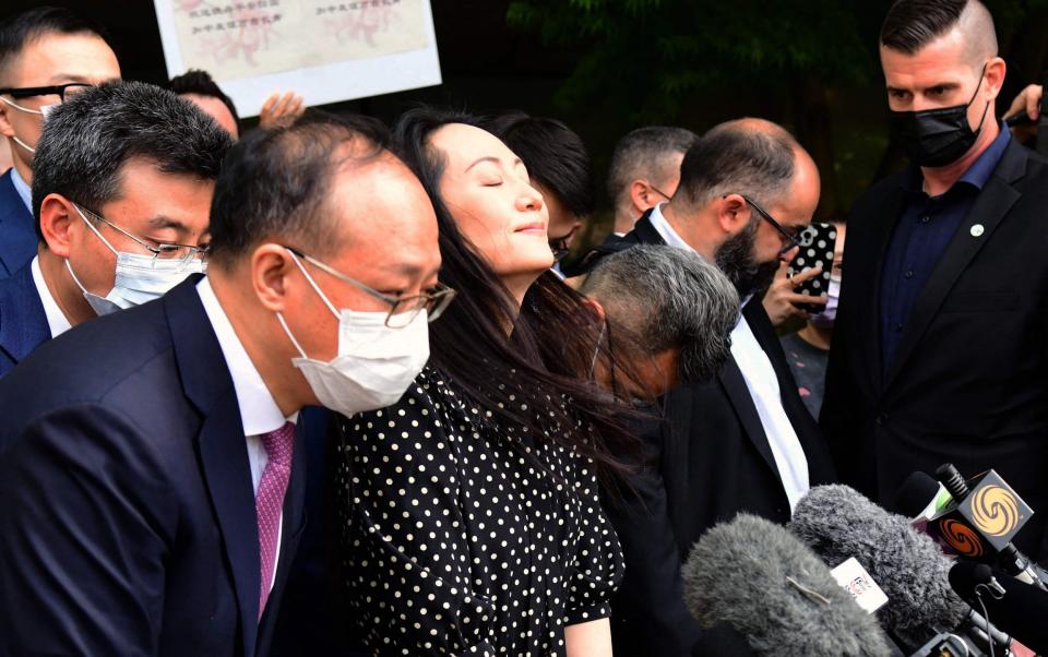 Huawei chief financial officer Meng Wanzhou talks to the media at British Columbia Supreme Court after her extradition hearing ended in her favour, in Vancouver British Columbia, Canada on Friday - DON MACKINNON/AFP