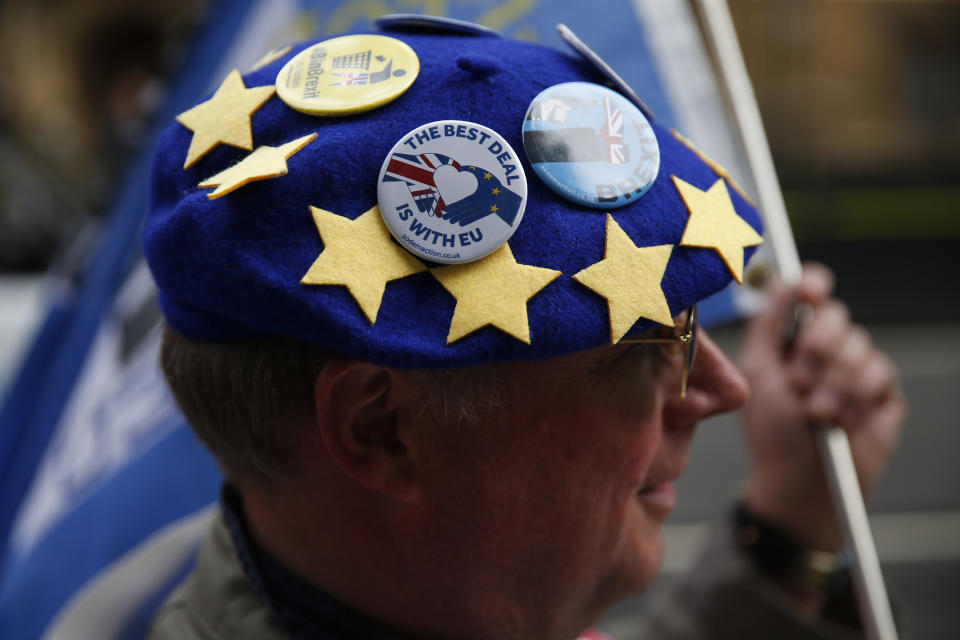 An anti-Brexit protester wears badges on a European flag design beret as he demonstrates outside the Houses of Parliament in London, Thursday, Sept. 26, 2019. British Prime Minister Boris Johnson faced a backlash from furious lawmakers Thursday over his use of charged and confrontational language in Parliament about opponents of his Brexit plan. (AP Photo/Matt Dunham)