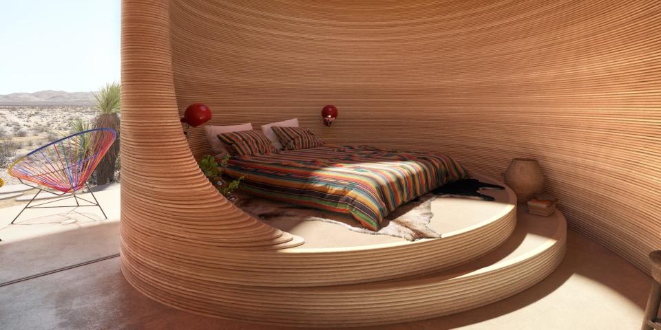 Renderings of the El Cosmico property shows the inside of a hotel room with curved walls and a bed.