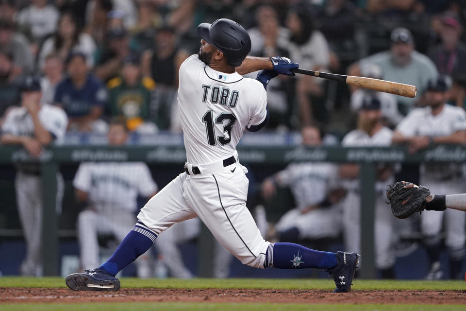 Seattle Mariners' Abraham Toro hits a two-run home run against the Houston Astros during the ninth inning of a baseball game Tuesday, July 27, 2021, in Seattle. Toro was traded to the Mariners from the Astros earlier in the day. The Astros won 8-6. (AP Photo/Ted S. Warren)