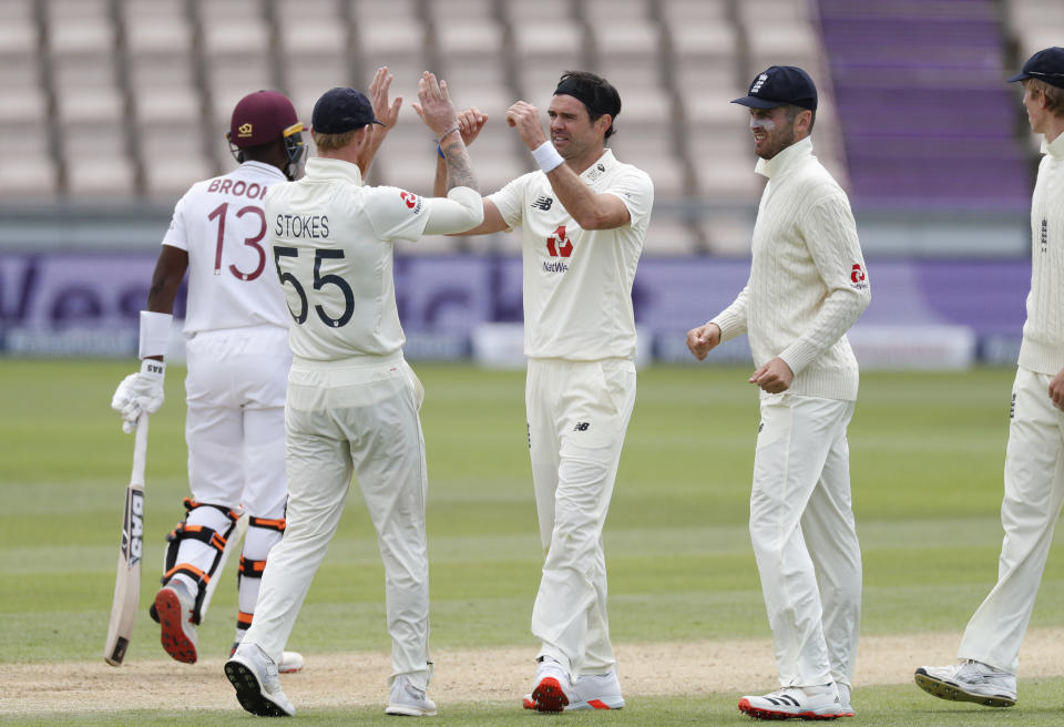 England's James Anderson, center, celebrates with teammates the dismissal of West Indies' Shamarh Brooks during the third day of the first cricket Test match between England and West Indies, at the Ageas Bowl in Southampton, England, Friday, July 10, 2020. (Adrian Dennis/Pool via AP)