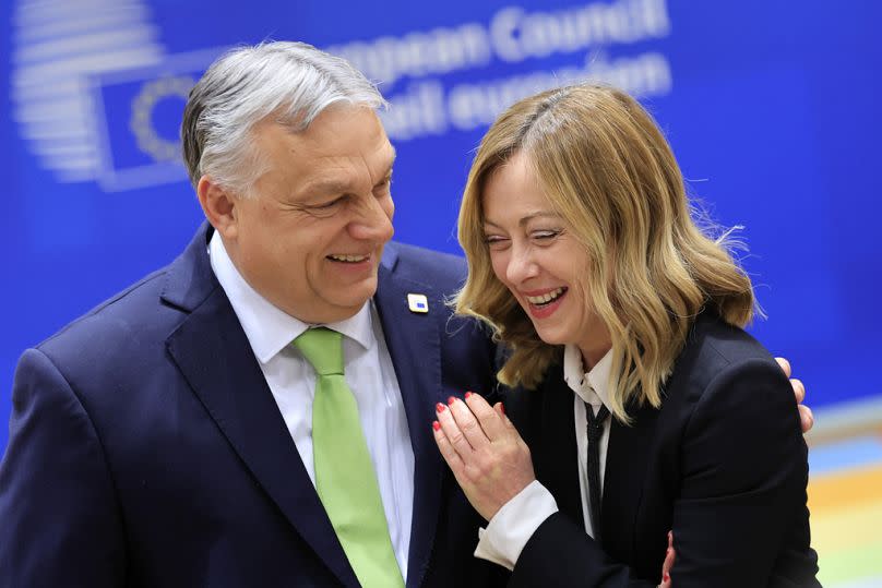 Hungary's Prime Minister Viktor Orban, left, speaks with Italy's Premier Giorgia Meloni during a round table meeting at an EU Summit in Brussels, on March 21, 2024.