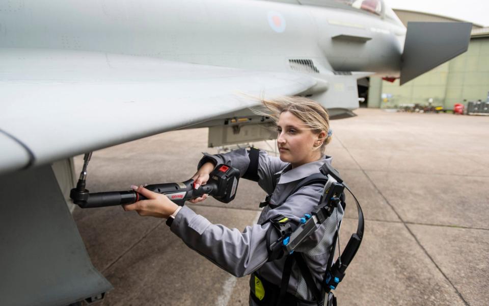 RAF Typhoon Support , BAE systems.Apprentice Typhoon maintainance engineer Alisha Wherrit tries out a prototype exo-skelital system to enable rapid servicing and maintainance of Typhoon skins and panels - David Rose for the Telegraph