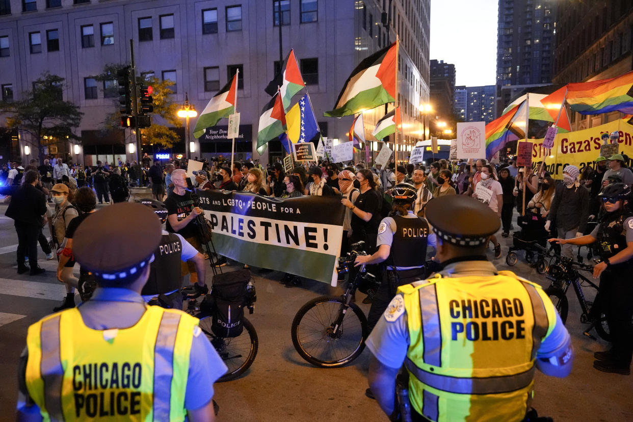 Protesters march passed a police line prior to the start of the Democratic National Convention Sunday, Aug. 18, 2024, in Chicago. (AP Photo/Alex Brandon)