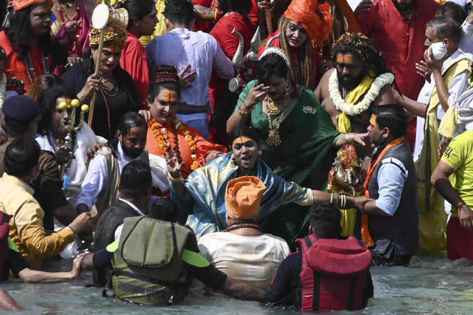 Followers of the Kinnar Akhara monastic Hindu order made up of transgender members take a holy dip in the waters of the River Ganges on the Shahi snan (grand bath) on the occasion of Maha Shivratri festival during the ongoing religious Kumbh Mela festival in Haridwar on March 11, 2021. (Photo by Prakash SINGH / AFP) (Photo by PRAKASH SINGH/AFP via Getty Images)