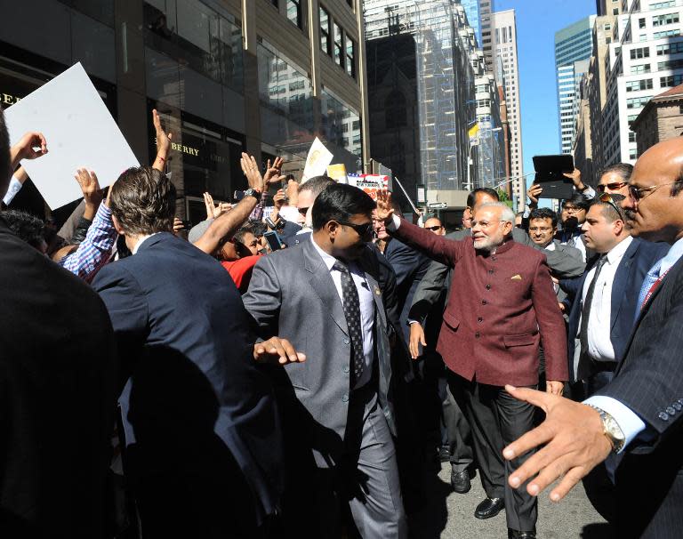 In this photograph released by the Press Information Bureau on September 27, 2014 and taken September 26, 2014, Indian Prime Minister Shri Narendra Modi (C) greets people on the streets of New York