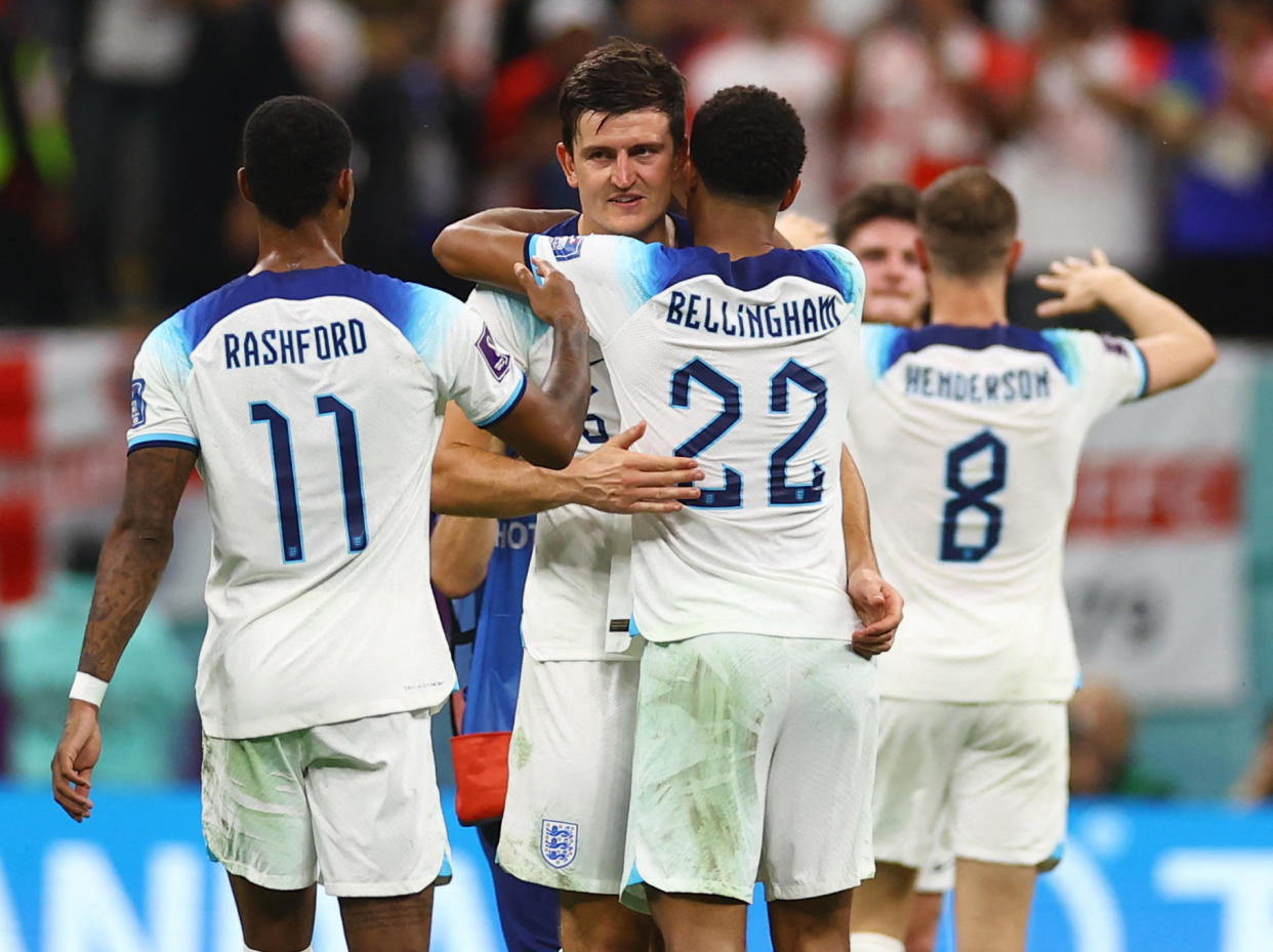 Soccer Football - FIFA World Cup Qatar 2022 - Round of 16 - England v Senegal - Al Bayt Stadium, Al Khor, Qatar - December 4, 2022 England's Harry Maguire, Jude Bellingham and Marcus Rashford celebrate qualifying for the quarter finals REUTERS/Kai Pfaffenbach