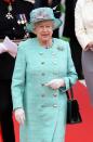 <p>For her visit to the East Midlands in 2012 The Queen opted for a rather fetching green overcoat with bold silver buttons. [Photo: Getty] </p>